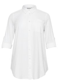 Hvid skjorte med knapper fremstillet af let stof. Har krave, enkelt brystlomme og opkrydsede ærmer. Runde kanter forneden.