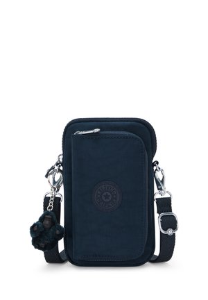 Piccola borsa a tracolla blu scuro con tasca frontale con zip, tracolla regolabile e portachiavi a forma di scimmia in peluche attaccato.