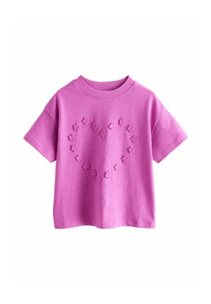 Purple cotton t-shirt with short sleeves, featuring floral appliqué in a heart shape on the front. Crew neckline and relaxed fit.