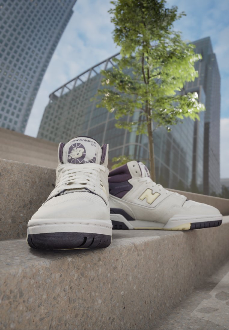 Sneaker New Balance con tomaia in pelle bianca, dettagli viola e suola in gomma nera, dotate di un logo circolare sulla linguetta.