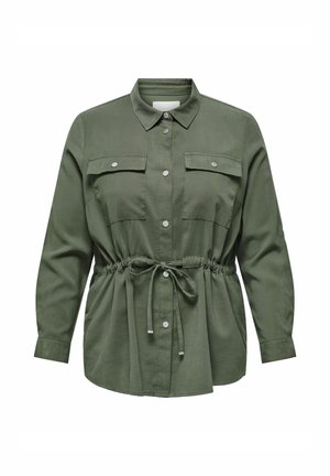Chemise vert olive avec un col, des manches longues, deux poches poitrine et une taille ajustable avec cordon de serrage. Finition en tissu lisse.