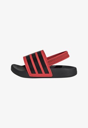 Infradito neri con una fascia rossa texturizzata decorata con tre strisce nere. La suola è liscia e curvata, progettata per comfort e aderenza.