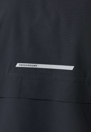 Dunkler Stoff mit einem horizontalen weißen Streifen in der Nähe einer Naht, auf dem der Text "SWEDEMOUNT" steht.