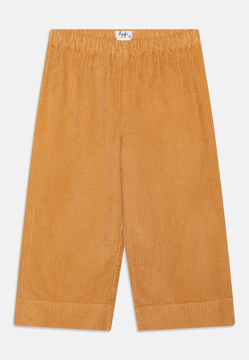 Meleg narancssárga kordbársony nadrág, bordás textúrával, rugalmas derékpánttal és egyenes lábbal, felhajtott szárakkal.