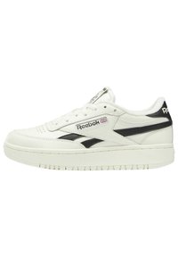 White leather sneaker with black accents, round toe, flat laces, textured sole, and Reebok logo on the side and tongue.