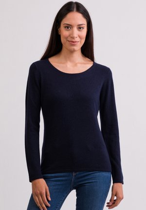 Pull bleu marine à manches longues en matière douce avec un col rond ; coupe ajustée, texture lisse et un léger éclat.