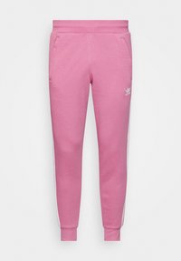 Pinkfarbene Jogginghose aus Baumwollmischung mit Seitentaschen, weißen Akzentstreifen und elastischen Bündchen. Logo am rechten Bein.