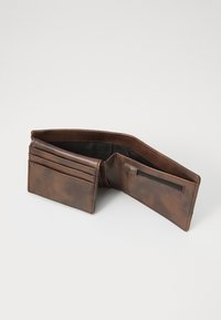 Brown leather wallet with a textured finish, featuring card slots, a zipped pocket, and a bi-fold design. Inner lining is dark.