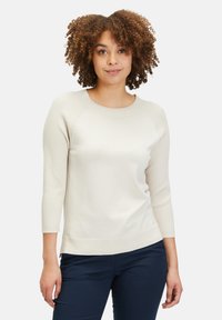 Cremfarbener Pullover mit Rippdetails am Kragen und an den Ärmeln, mit lockerer Passform und dreiviertellangen Ärmeln.