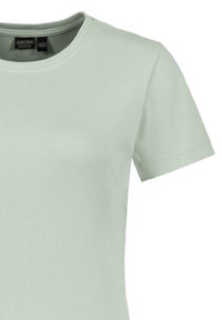 Hellgrünes, geripptes T-Shirt mit Rundhalsausschnitt und kurzen Ärmeln, das über eine dezente Textur und eine Etikettierung im Krageninneren verfügt.