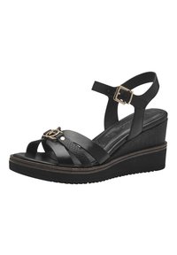 Black wedge sandals feature a textured strap and a gold-tone buckle. The design includes multiple cross straps and a textured heel for stability.