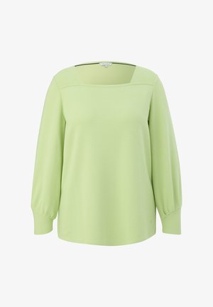 Svijetlozelena majica s kvadratnim izrezom, dugim, blago napuhanih rukavima i teksturiranom tkaninom. Ima opušteni kroj i suptilne detalje šavova.