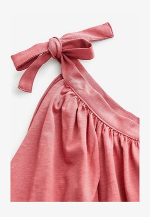 Kortsärg rikka koha ja lipsuga rihmaga. Valmistatud pehmest kangast, millel on sile tekstuur ja peen heather muster.