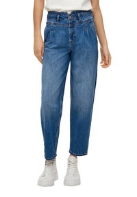 Blue high-waisted jeans with a relaxed fit, featuring a button closure and front pleats. Paired with white chunky sneakers.
