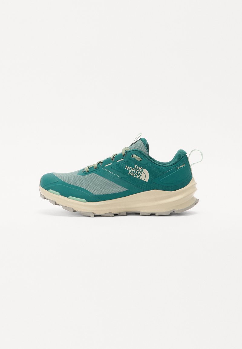 Teal athletic shoe featuring a mesh upper, cushioned cream midsole, textured rubber sole, and reinforced eyelets for laces.