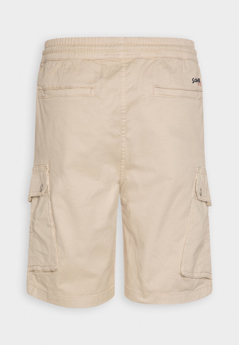 Shorts cargo beiges avec taille élastique, deux poches à rabat sur les côtés et deux poches passepoilées à l'arrière, arborant un petit logo brodé sur le côté droit.