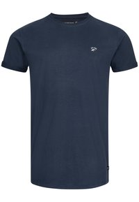 Navyblaue Baumwoll-T-Shirt mit kurzen, aufgeschlagenen Ärmeln, rundem Halsausschnitt und einem kleinen weißen Logo auf der oberen linken Seite. Klassische Passform.