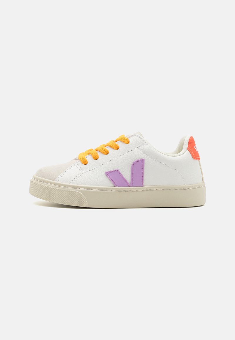 White leather sneaker with orange laces, a purple logo on the side, and a textured beige rubber sole. Rounded toe and padded collar.