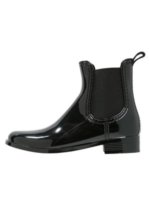 Black patent ankle boot with elastic side panels. Features rounded toe and low block heel. Smooth texture, sleek design, with pull tab at heel.