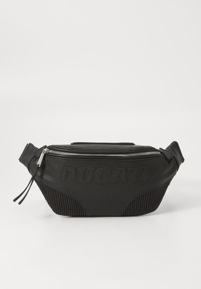 Black fanny pack made of leather and ribbed fabric. Features a silver zipper and embossed "DUCATI" logo on the front. Compact and structured design.