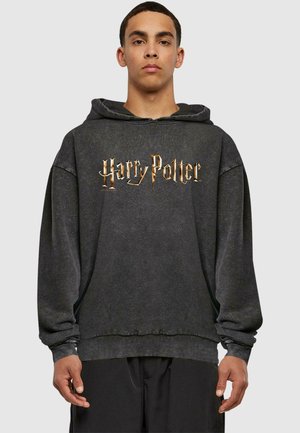 Grå hættejakke med en front kangaroo-lomme, snøre i hætten og "Harry Potter" logo i guld. Lavet af blødt, struktureret stof. Oversized pasform.