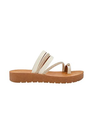 Sandale beige avec une semelle compensée marron avec deux larges brides, une bride scintillante et une boucle d’orteil avec une perle décorative.