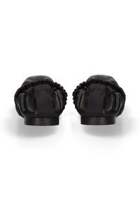 Black leather ballet flats with gathered elastic edges shown from the back on a white background.