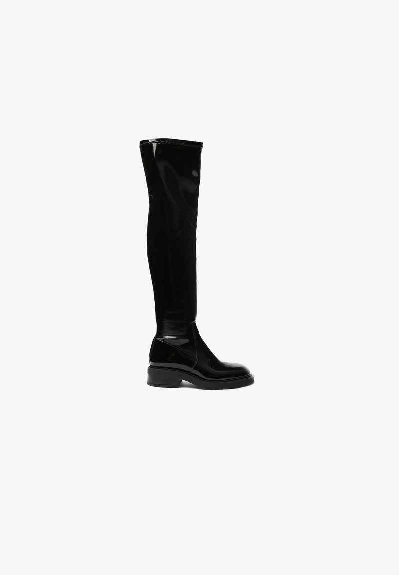 Black knee-high boots in glossy material featuring a rounded toe, chunky sole, and seamless construction on the leg section.