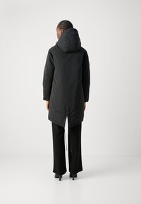 Black padded parka with a hood, featuring a long hem, two side seams, and adjustable drawstring at the waist, set against a neutral background.