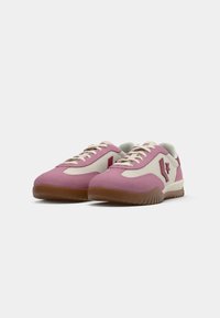 Pink and cream sneakers with a textured suede upper and rubber sole, featuring a prominent star logo and contrasting laces.