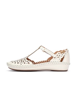 Sandale compensée pour femme en cuir blanc crème avec bride en T, découpes décoratives et détail de semelle cousue.