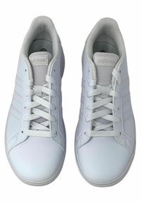 White sneakers made of smooth synthetic material. Features include round toe, lace-up front, padded collar, and three diagonal stripes on the sides.