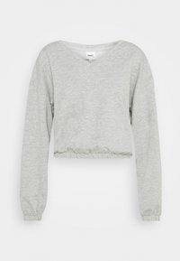 Felpa cropped grigia chiara realizzata in tessuto morbido, dotata di scollo a V, maniche lunghe ed orlo elasticizzato. Nessun motivo o dettaglio visibile.