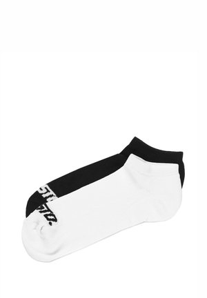 Skarpety do kostki z bawełnianej mieszanki, z czarną górną częścią i białą dolną częścią, z kontrastowym logo na czarnej stronie.