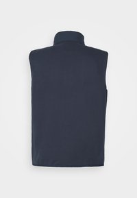 Mörkblå ärmlös väst med hög krage, slät yta och utan synliga knäppningar eller mönster, designad för lager-på-lager och komfort.