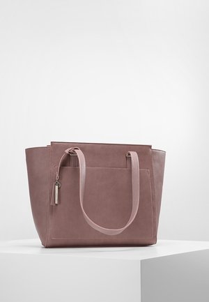 Mauve lædertaske med forreste lynlåslomme og to skulderstropper, vist på en hvid piedestal mod en ensfarvet baggrund.