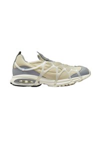 Beige and gray athletic shoe with a mesh upper, plastic overlay design, and a cushioned sole featuring an air pocket for support.
