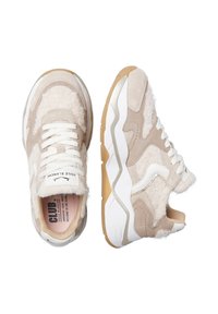 Chunky sneakers in beige and cream tones, featuring suede and plush accents, white laces, and a textured rubber sole with gold detailing.
