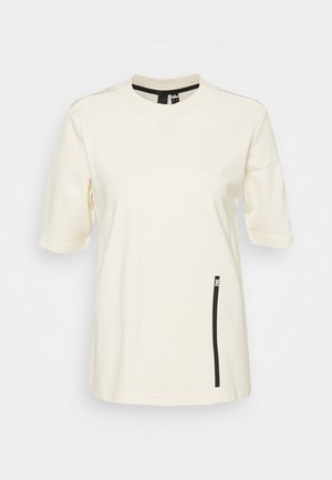 Cremfarbendes T-Shirt mit kurzen Ärmeln und rundem Halsausschnitt. Verfügt über ein schwarzes Reißverschluss-Taschen-Detail auf der linken Seite. Weicher, strukturiertes Gewebe.