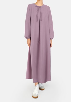 Luźna sukienka z długim rękawem wykonana z miękkiej, lawendowej tkaniny. Posiada okrągły dekolt z regulowanym sznurkiem, noszona z białymi trampkami.