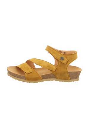 Gelbe Wildleder-Sandalette mit zwei verstellbaren Riemen, gepolstertem Fußbett und Korkkeilsohle. Mit einem dekorativen Metallelement.