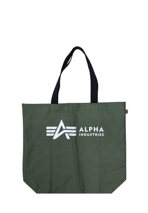 Green tote bag with black handles, featuring white "Alpha Industries" logo and text on the front.