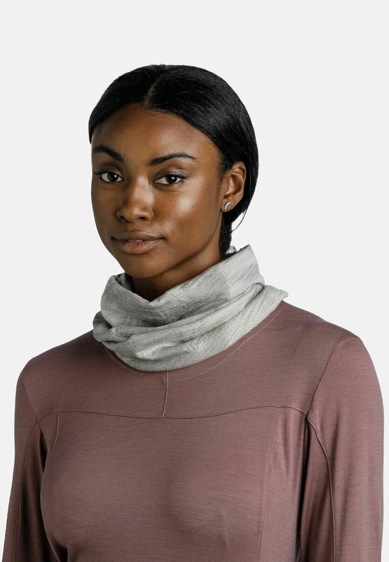 Gray neck gaiter made of soft fabric, worn over a mauve long-sleeve top. The gaiter has a slightly textured appearance and relaxed fit.