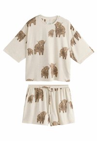 Beige loungewearset bestaande uit een kortemouwtop en shorts. Beide zijn bedrukt met bruine harige dierenafbeeldingen. Zacht, relaxte pasvorm.