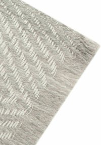 Woven gray area rug featuring a textured chevron pattern in lighter shades, with a soft, fibrous surface and clean edges.