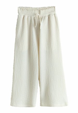Krémové široké nohavice s textúrovanou látkou, elastickým pásom a šnúrkou na zaväzovanie vpredu.