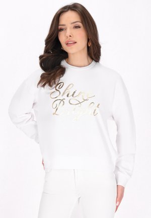 Weißes Sweatshirt aus weichem Stoff, mit der metallisch goldenen Aufschrift "Shine Bright" in Schreibschrift. Lockerer Schnitt mit langen Ärmeln.