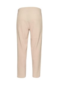 Pantalones beige de canalé con corte relajado y cintura elástica. Largo recortado con la entrepierna llegando a la mitad de la pantorrilla, textura suave y sin patrones.