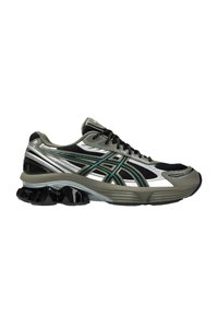 Scarpa da corsa con tomaia in rete nera e accenti argento e verde, suola imbottita e un distintivo tallone a forma di onda nera.