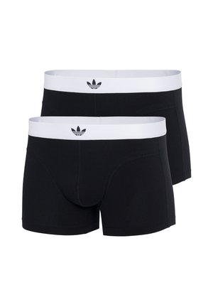 Boxer shorts noirs avec une ceinture élastique blanche portant un logo, fabriqués à partir d'un tissu lisse et extensible, épousant étroitement le corps.
